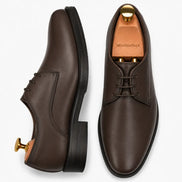 Brown leather plain-toe Derby, three-quarter angle showing heel and clean upper