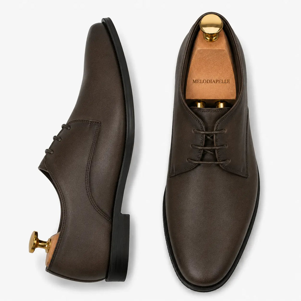 Brown leather plain-toe Derby, three-quarter angle showing heel and clean upper