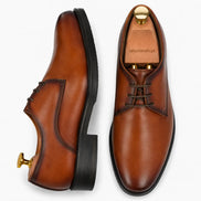 Cognac tan leather plain Derby, three-quarter angle showing heel and Goodyear-welted stitching