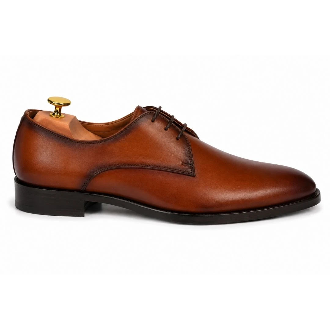 Side profile of the Mangrove Plain Derby in cognac tan leather on white background