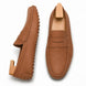 Rust tan leather penny loafer, three-quarter angle showing sole detailing