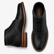 Black leather plain-toe boot, three-quarter angle showing heel and contrast stitching