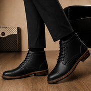 Melodiapelle Manila Plain Toe Boot in black leather worn with trousers, on-feet shot