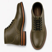 Olive green leather plain-toe boot, three-quarter angle showing heel and contrast stitching