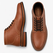 Tan leather plain-toe boot, three-quarter angle showing heel and contrast stitching