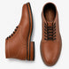 Tan leather plain-toe boot, three-quarter angle showing heel and contrast stitching