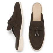 Dark brown suede tassel mule loafer, three-quarter angle showing tassel and heel