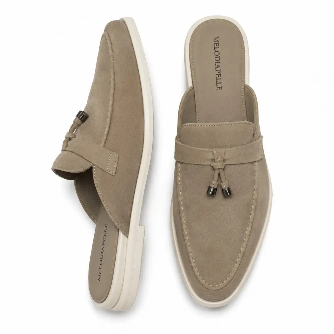 Sand beige suede tassel mule loafer, three-quarter angle showing tassel and heel