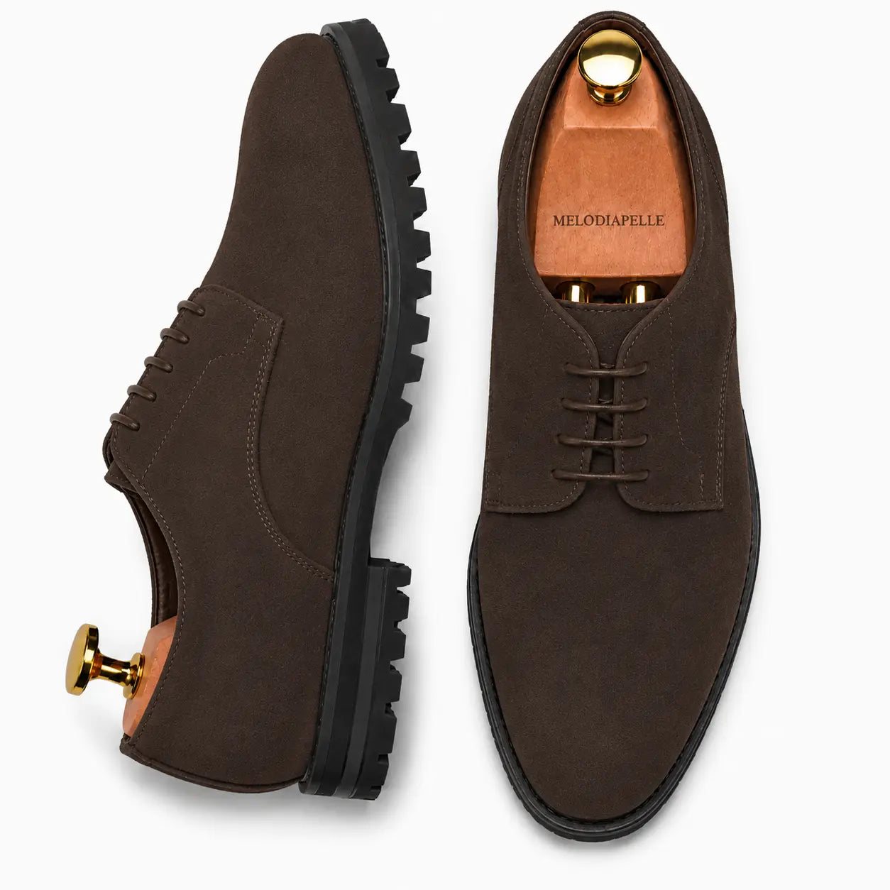Dark brown suede plain-toe Derby, three-quarter angle showing heel and sole detailing