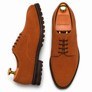 Rust tan suede plain-toe Derby, three-quarter angle showing heel and sole detailing