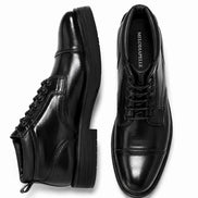 Black leather combat boot, three-quarter angle showing heel and sole detailing
