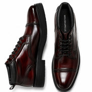Burgundy leather combat boot, three-quarter angle showing heel and sole detailing