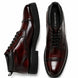 Burgundy leather combat boot, three-quarter angle showing heel and sole detailing