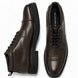 Dark brown leather combat boot, three-quarter angle showing heel and sole detailing