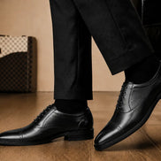 Marcello Semi-Brogue Oxford in nero black leather worn with formal trousers, on-feet lifestyle shot
