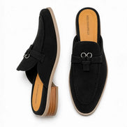 Black suede bit-buckle mule loafer, three-quarter angle showing buckle and heel