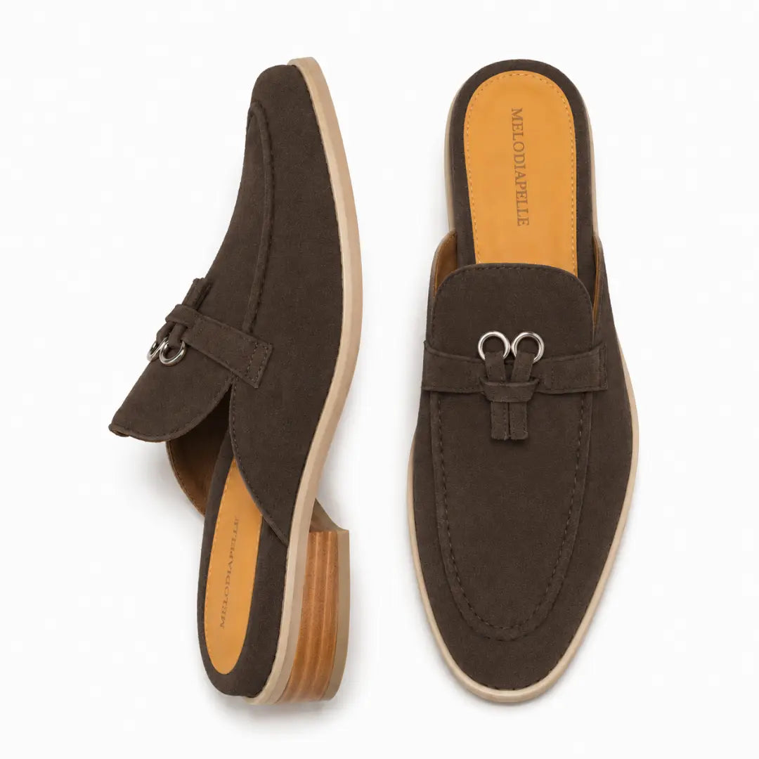 Dark brown suede bit-buckle mule loafer, three-quarter angle showing buckle and heel