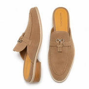 Sand beige suede bit-buckle mule loafer, three-quarter angle showing buckle and heel