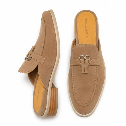 Sand beige suede bit-buckle mule loafer, three-quarter angle showing buckle and heel