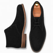 Black suede chukka boot, three-quarter angle showing heel and sole detailing