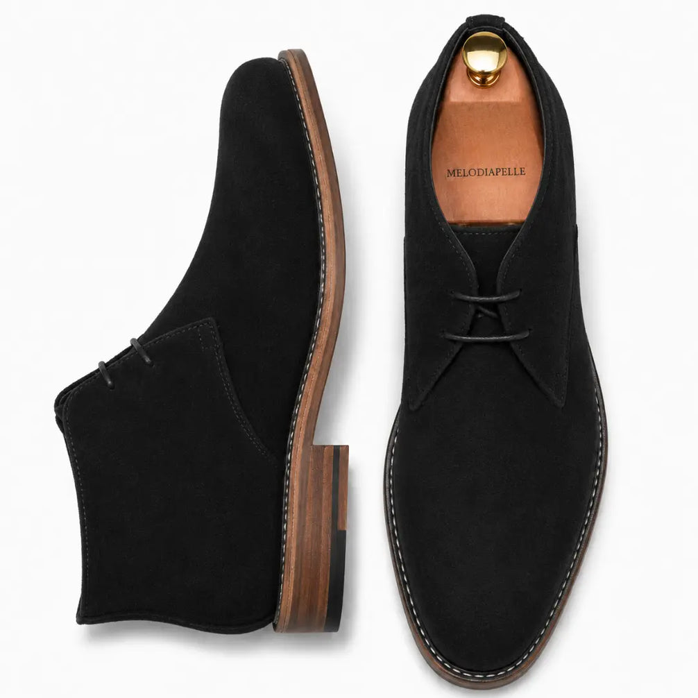 Black suede chukka boot, three-quarter angle showing heel and sole detailing