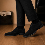 Melodiapelle Maringa Suede Chukka Boot in black suede worn with trousers, on-feet shot