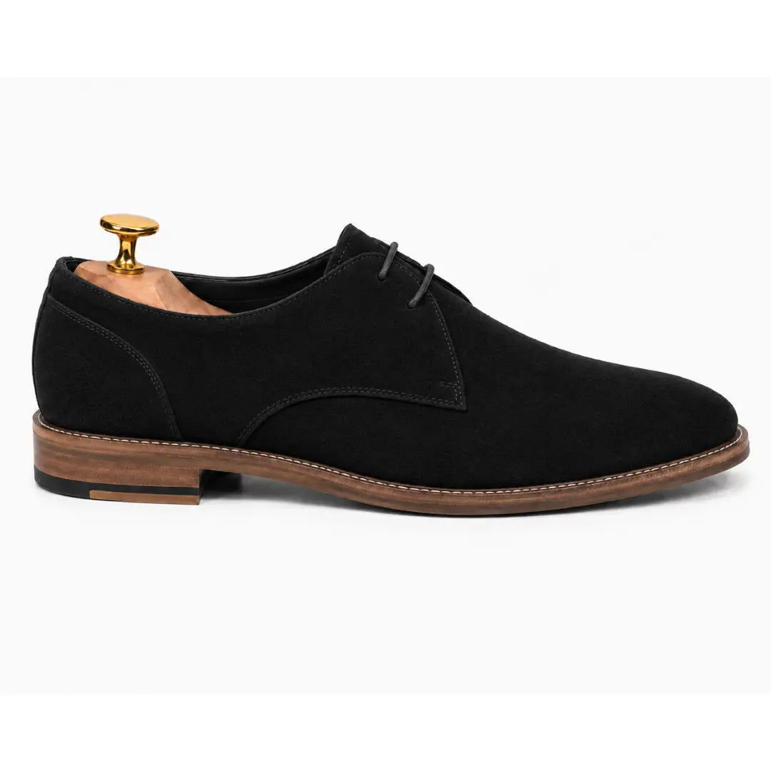Side profile of the Maringa Suede Chukka Boot in black suede on white background