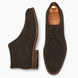 Dark brown suede chukka boot, three-quarter angle showing heel and sole detailing