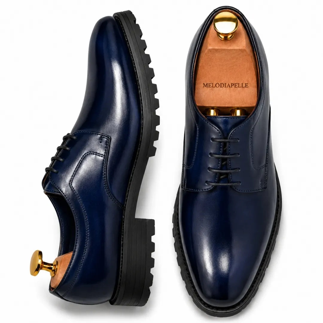 Navy blue leather plain-toe Derby, three-quarter angle showing heel and sole detailing