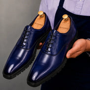 Man holding a pair of Melodiapelle Marlboro Derby Shoes in navy blue leather, close-up