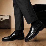 Melodiapelle Marquis Dress Penny Loafer in black leather worn with formal trousers, on-feet shot