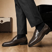 Melodiapelle Marquis Dress Penny Loafer in brown leather worn with formal trousers, on-feet shot