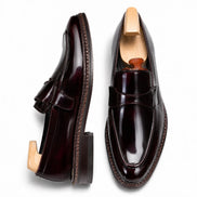 Oxblood burgundy leather dress penny loafer, three-quarter angle showing heel and penny strap