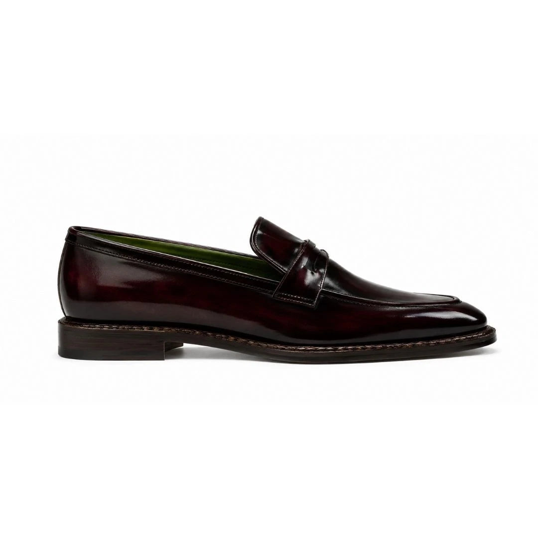 Side profile of the Marquis Dress Penny Loafer in oxblood burgundy leather on white background