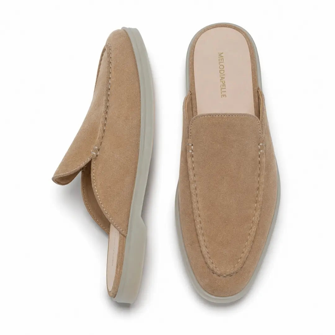 Sand beige suede backless mule loafer, three-quarter angle showing heel and sole detailing
