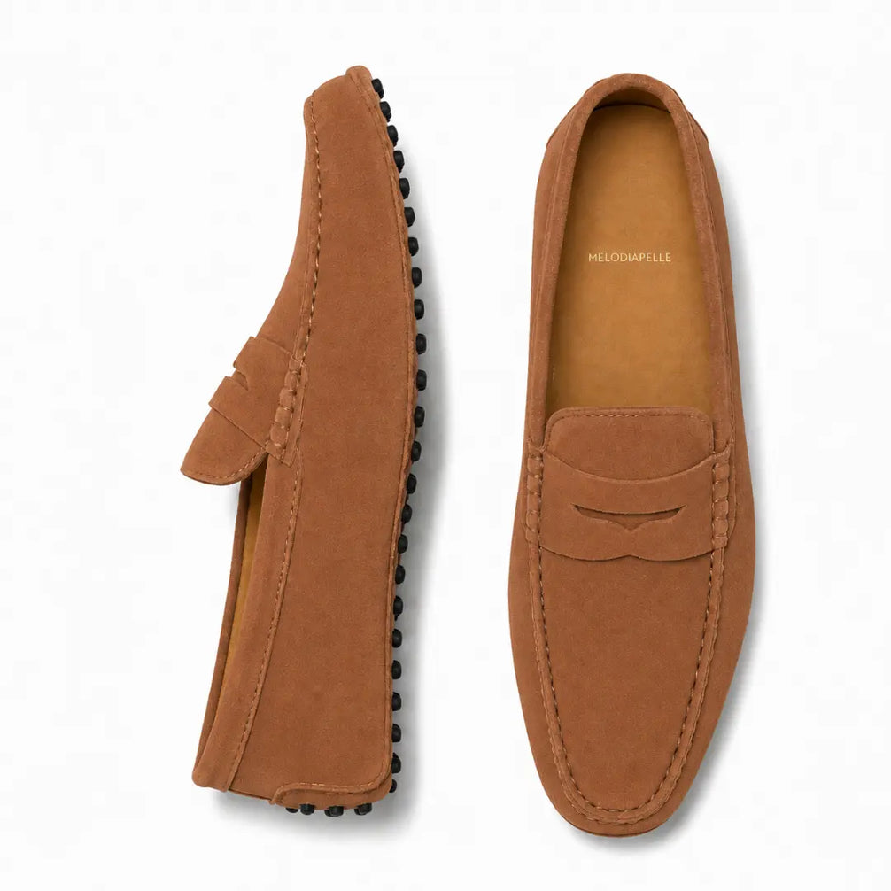 Rust tan suede penny loafer, three-quarter angle showing sole detailing