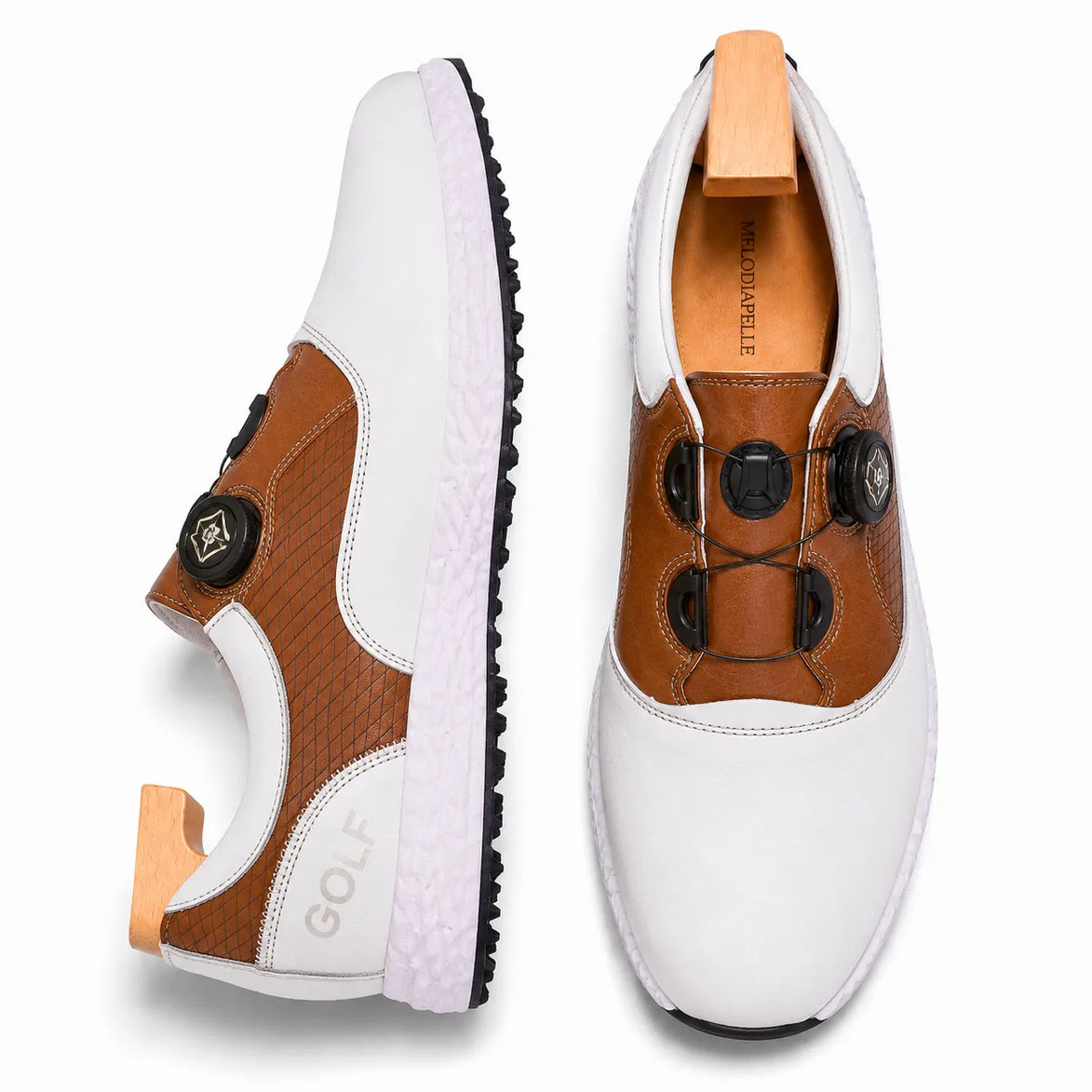 White and tan leather golf shoe, three-quarter angle showing BOA dial closure and sole detailing