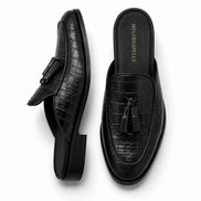 Black croc-embossed leather tassel mule, three-quarter angle showing tassel and heel