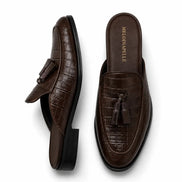 Dark brown croc-embossed leather tassel mule, three-quarter angle showing tassel and heel