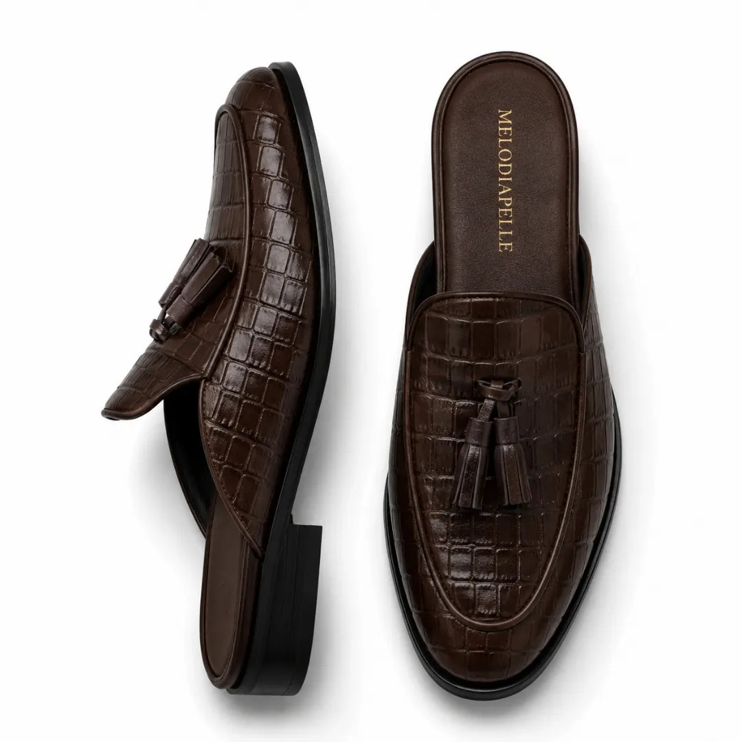 Dark brown croc-embossed leather tassel mule, three-quarter angle showing tassel and heel