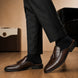 Melodiapelle Mason Mule in dark brown croc-embossed leather worn with formal trousers, on-feet shot