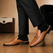 Melodiapelle Mason Mule in tan croc-embossed leather worn with formal trousers, on-feet shot