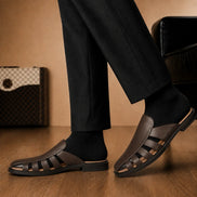 Melodiapelle Mason Mule in dark brown leather worn with trousers, on-feet shot