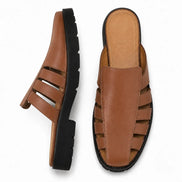 Tan leather caged mule, three-quarter angle showing cutout panel and sole detailing