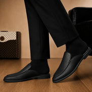 Melodiapelle Massimo Mule in black leather worn with trousers, on-feet shot
