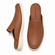 Tan leather backless mule loafer, three-quarter angle showing heel and sole detailing