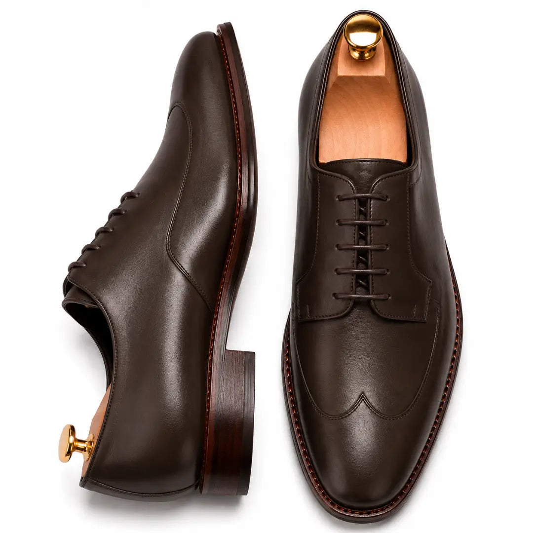 Dark brown leather apron-toe Derby, three-quarter angle showing heel and brogue detailing
