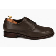 Side profile of the Matador Apron-Toe Derby in dark brown leather on white background