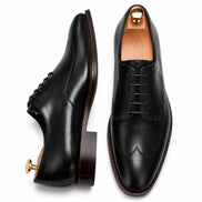 Nero black leather apron-toe Derby, three-quarter angle showing heel and brogue detailing