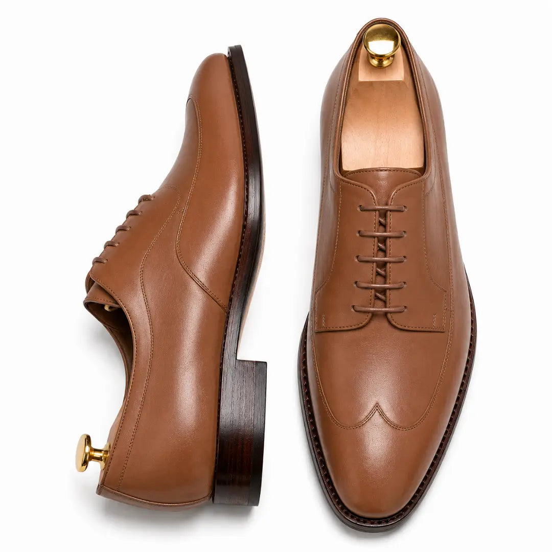 Tan leather apron-toe Derby, three-quarter angle showing heel and brogue detailing